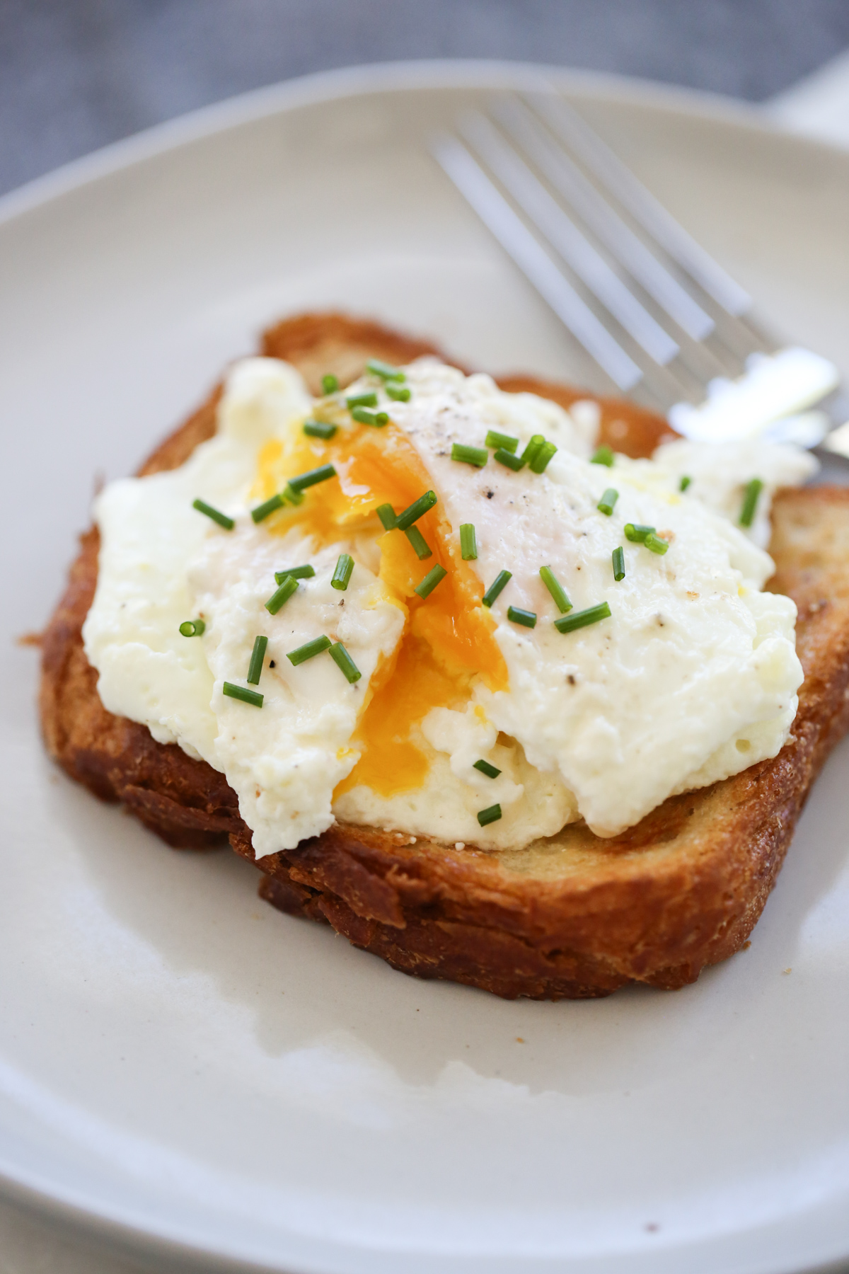 cream fried egg on toast with chives