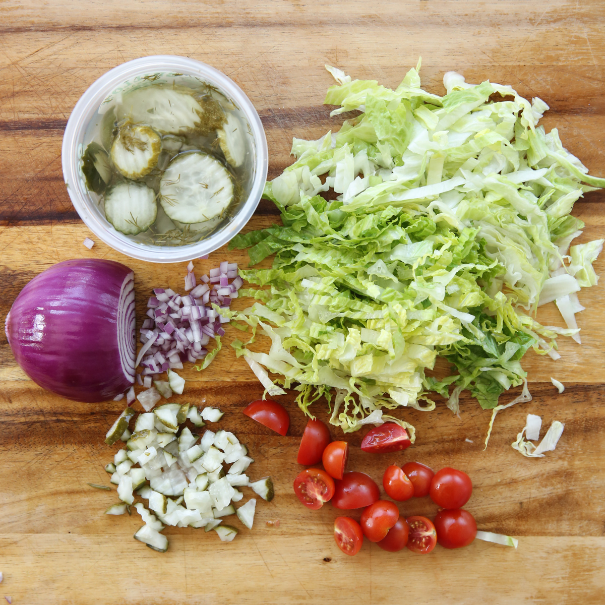 cheeseburger salad ingredients on a cutting board
