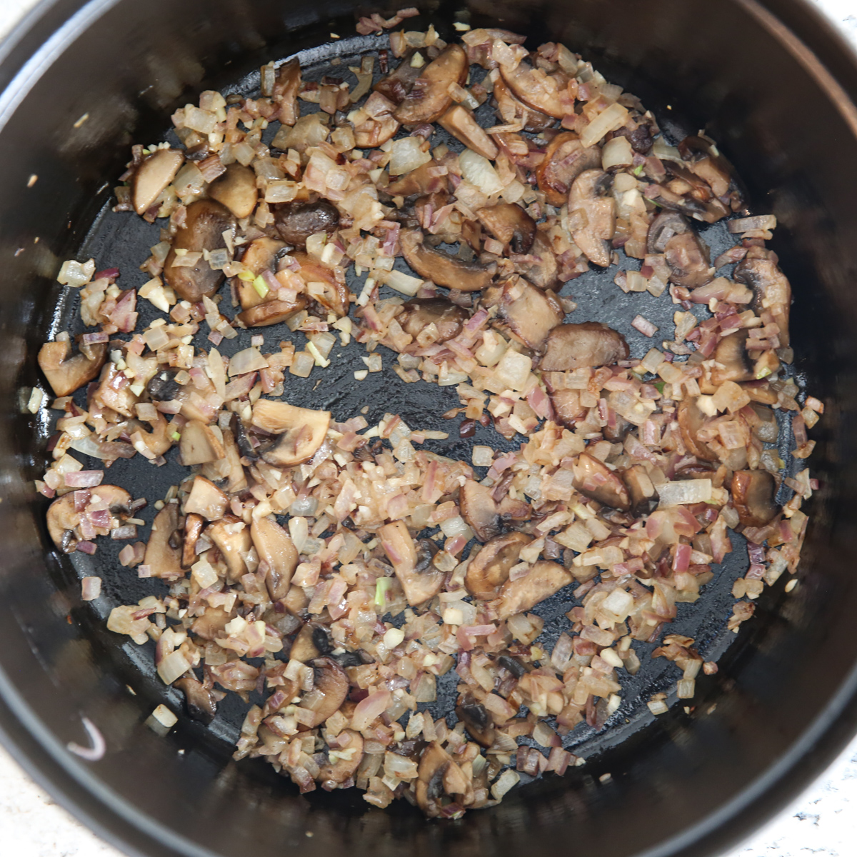 onion and mushrooms in a stock pot