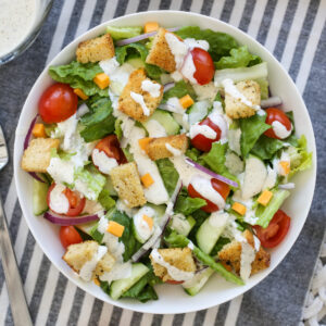 Classic House Salad in a bowl with ranch dressing drizzle