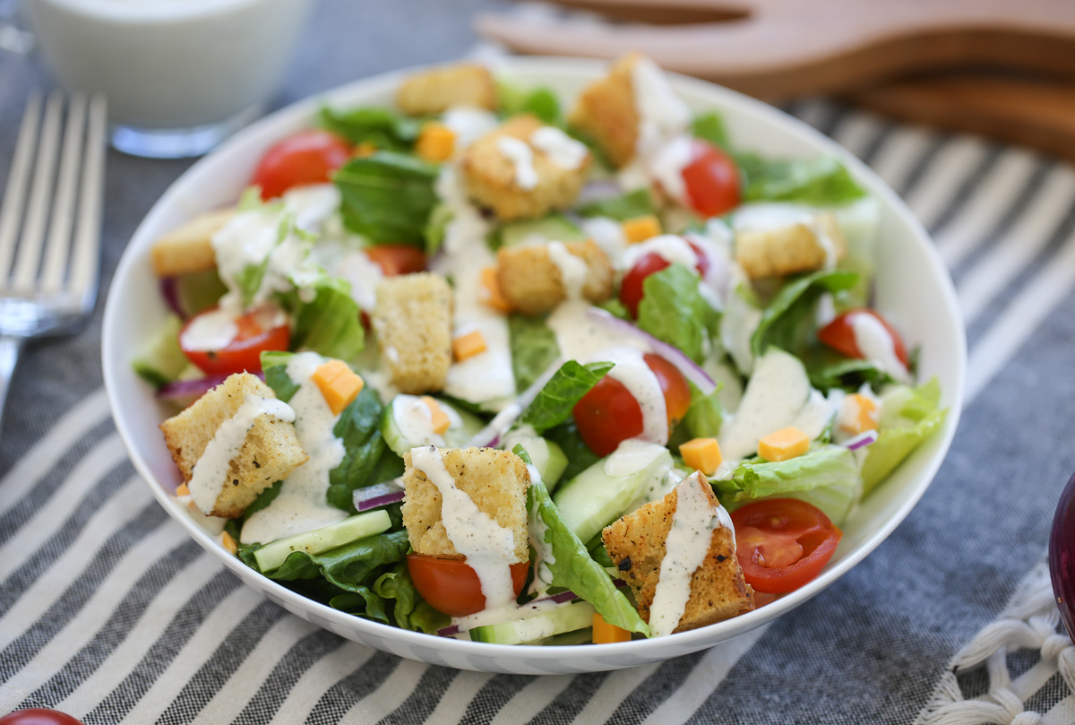 Classic House Salad in a bowl with ranch dressing drizzle