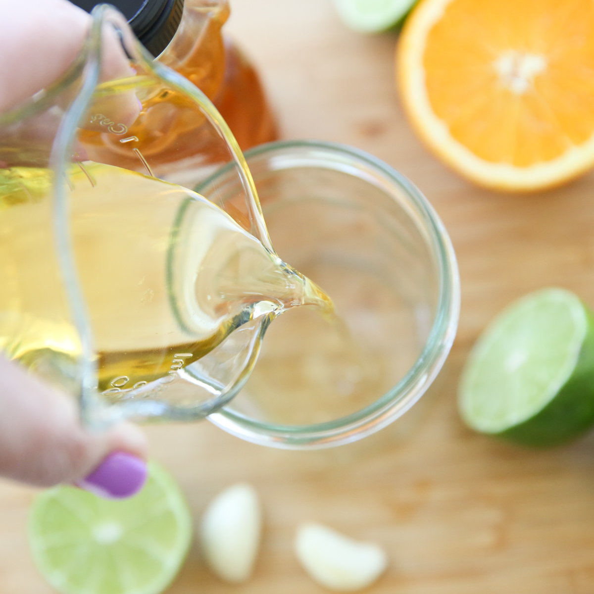 pouring oil into salad dressing jar