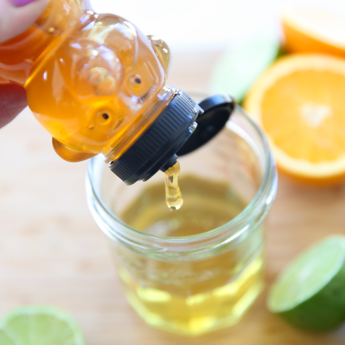 drizzling honey into salad dressing jar