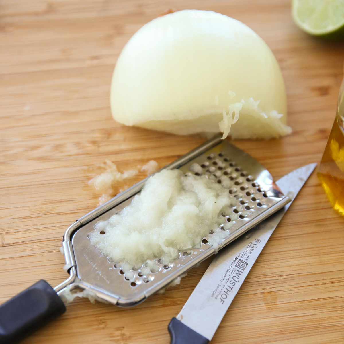 onion being grated on a cheese grater