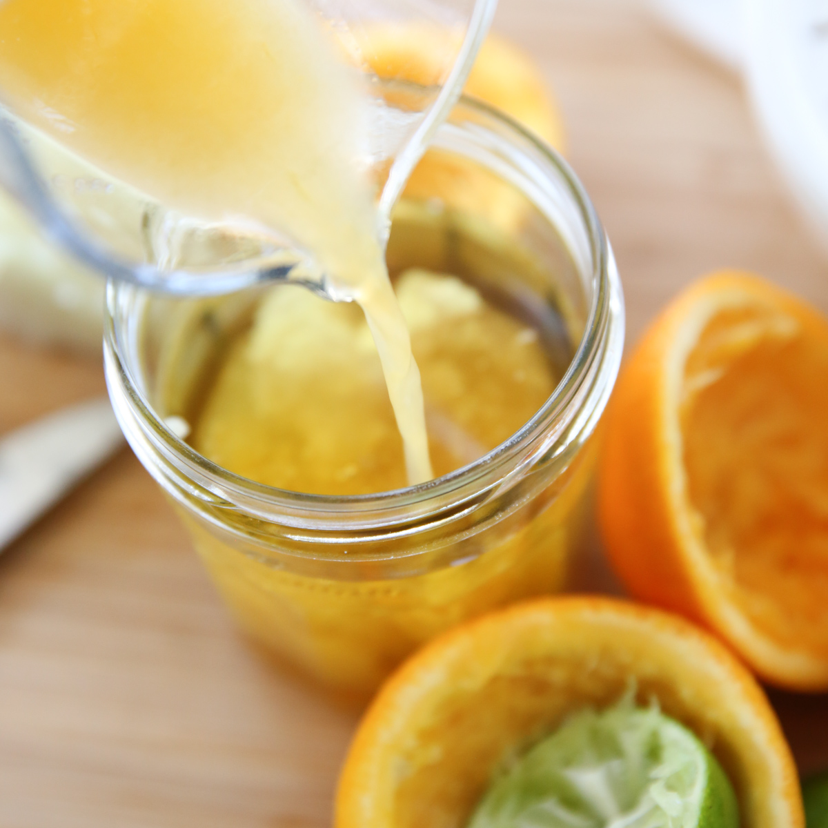 pouring juice into jar of salad dressing