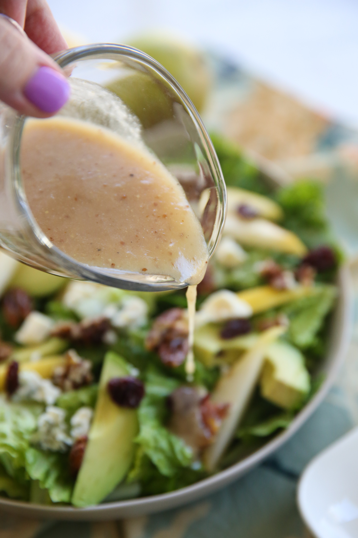 pouring dressing on Pear and Blue Cheese Salad