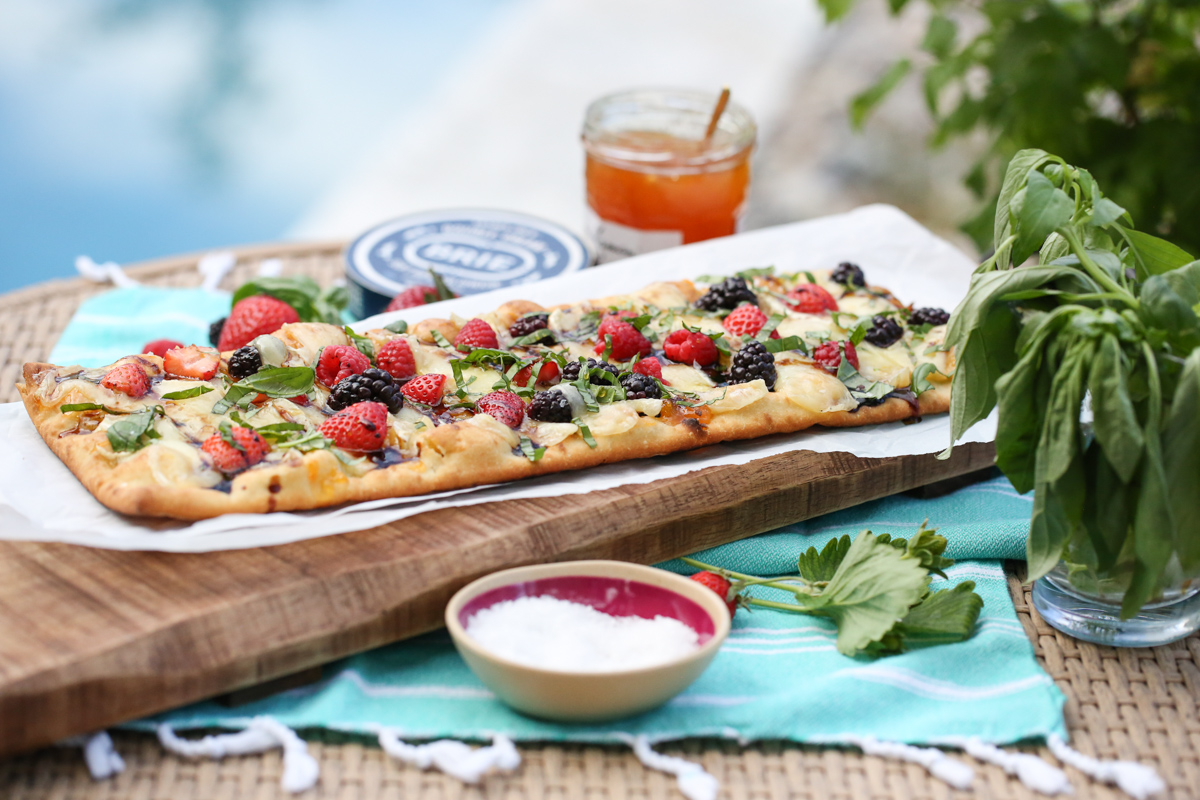 Berry an Brie flatbread on a table in front of a pool