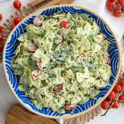creamy pesto basil pasta in a blue and white serving bowl