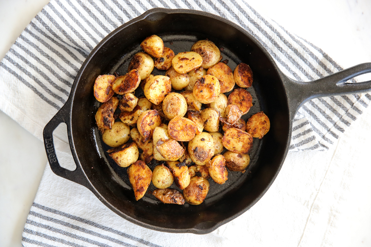 Crispy potatoes in a cast iron skillet.