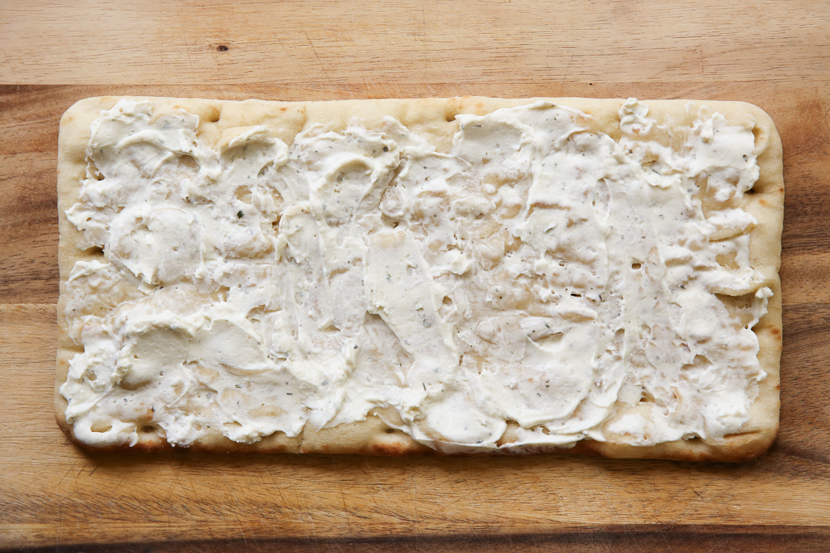 Cheesesteak flatbread on a cutting board