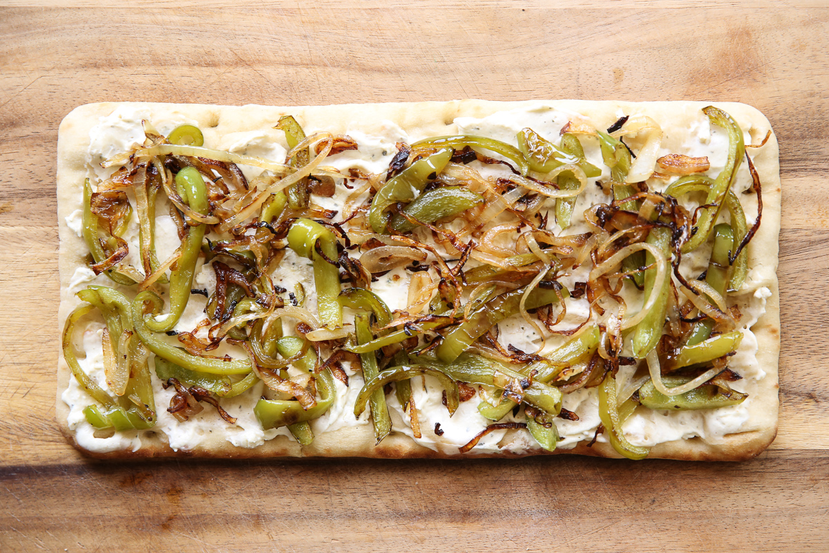 Cheesesteak flatbread on a cutting board