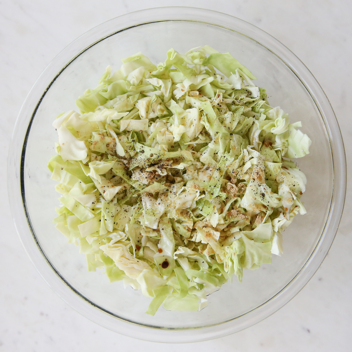 cabbage slaw ingredients in a glass bowl
