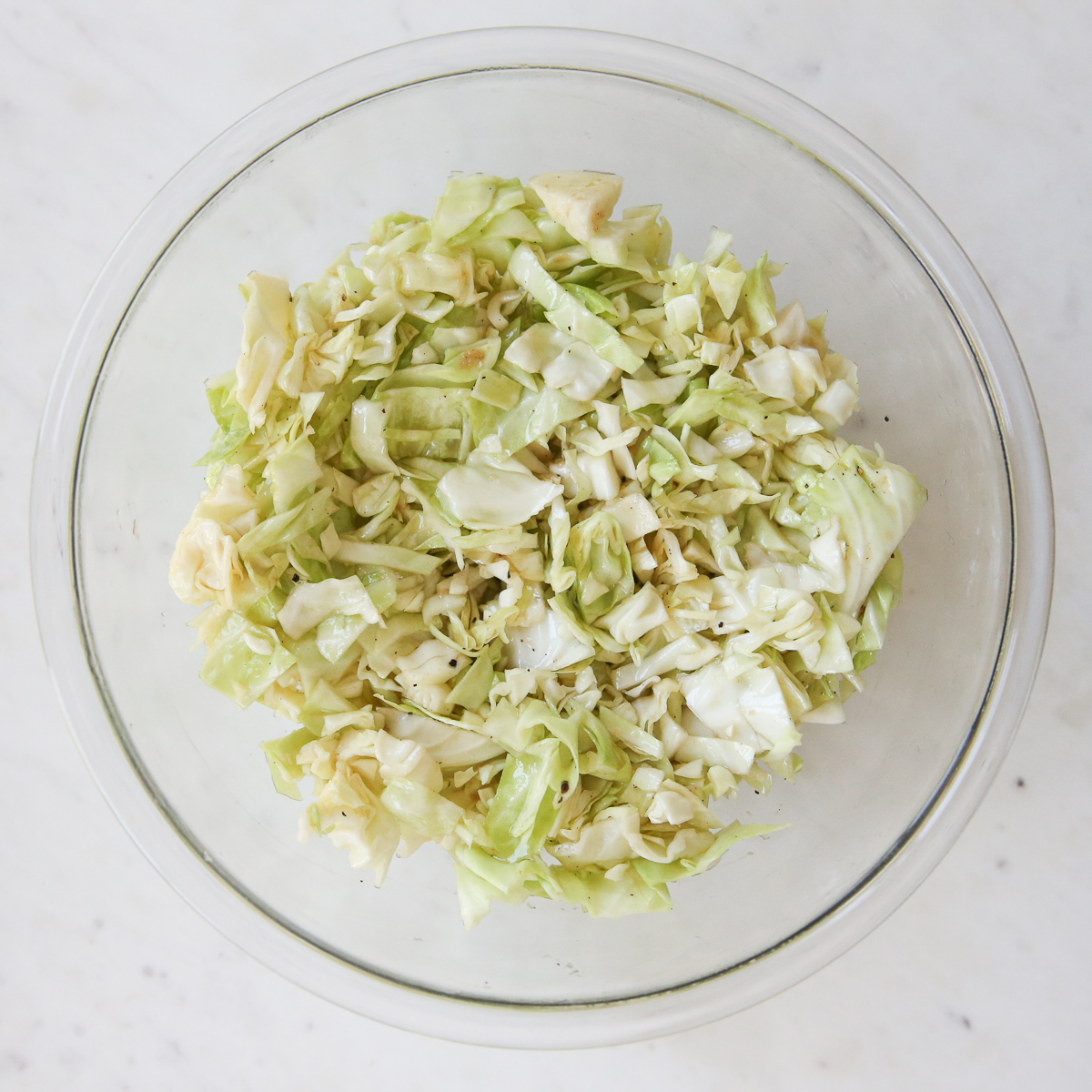 cabbage slaw ingredients in a glass bowl