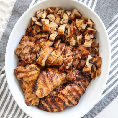 Grilled Chicken thighs in a white bowl