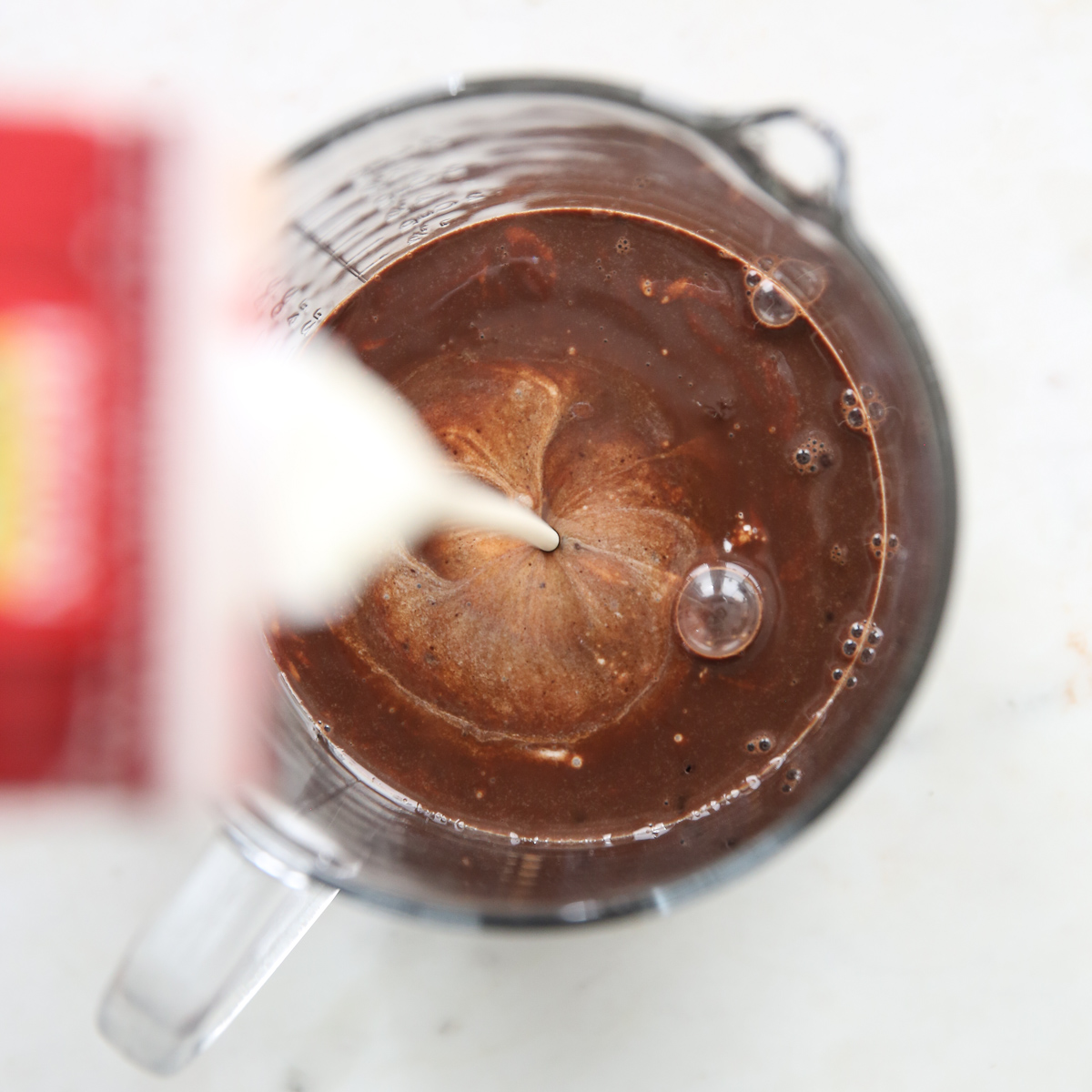 adding cream to chocolate ice cream base