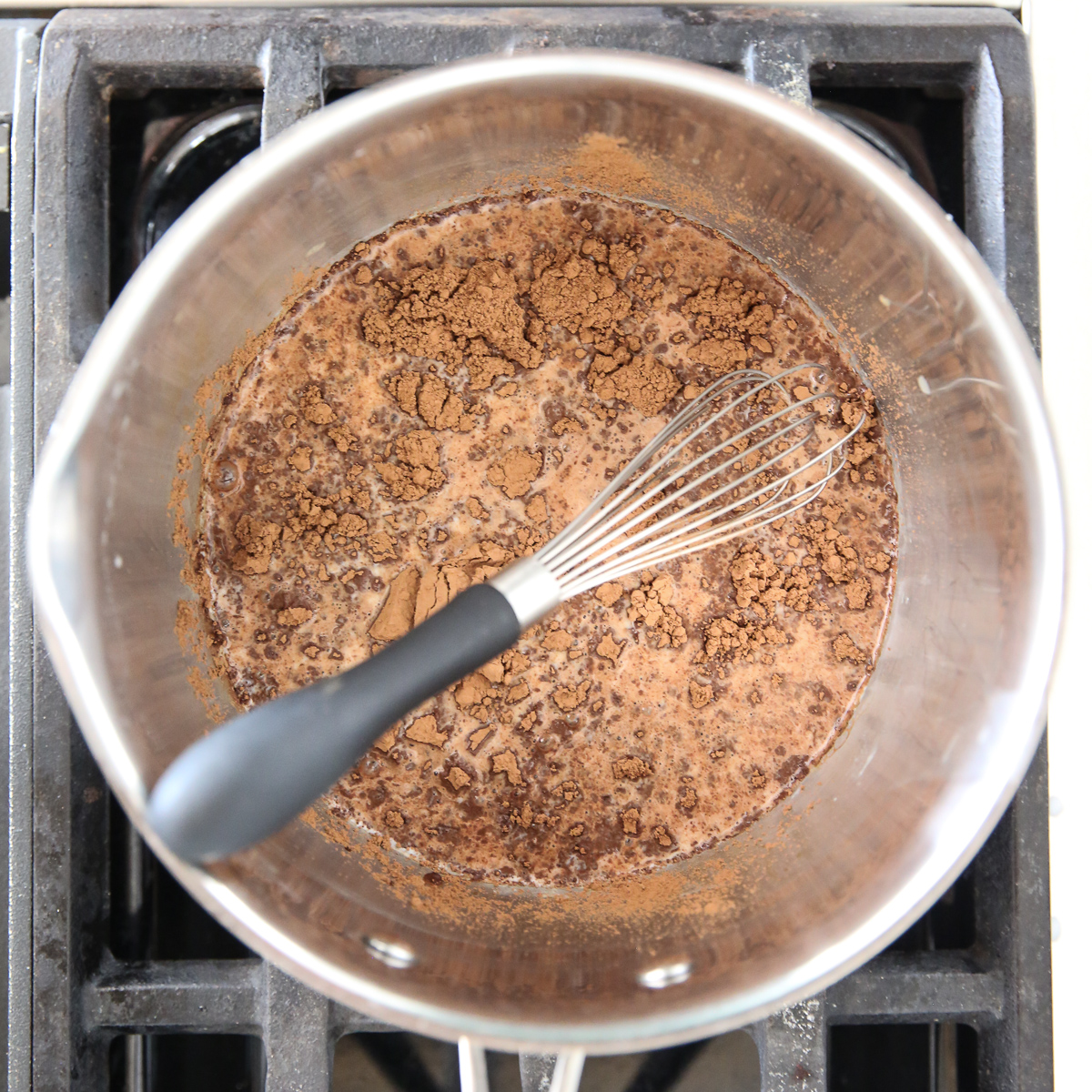 cocoa powder in simmering milk