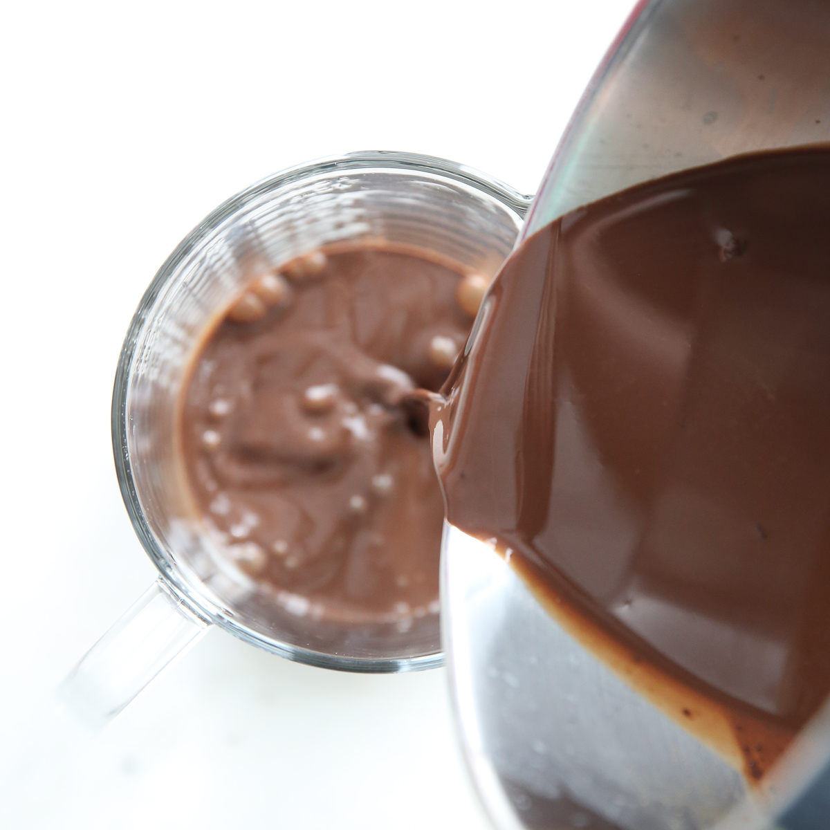 pouring cocoa milk into measuring cup