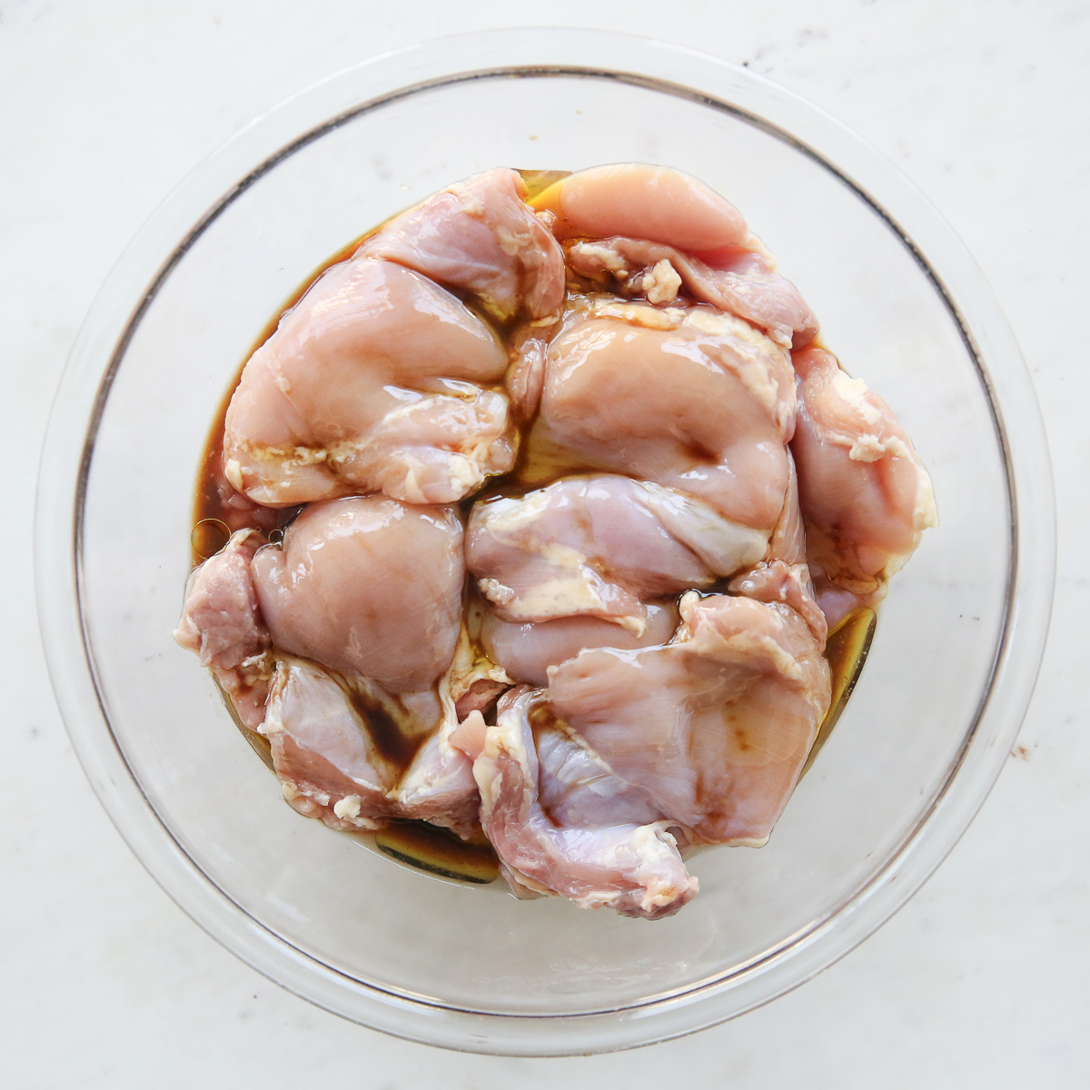 chicken thighs marinating with seasonings