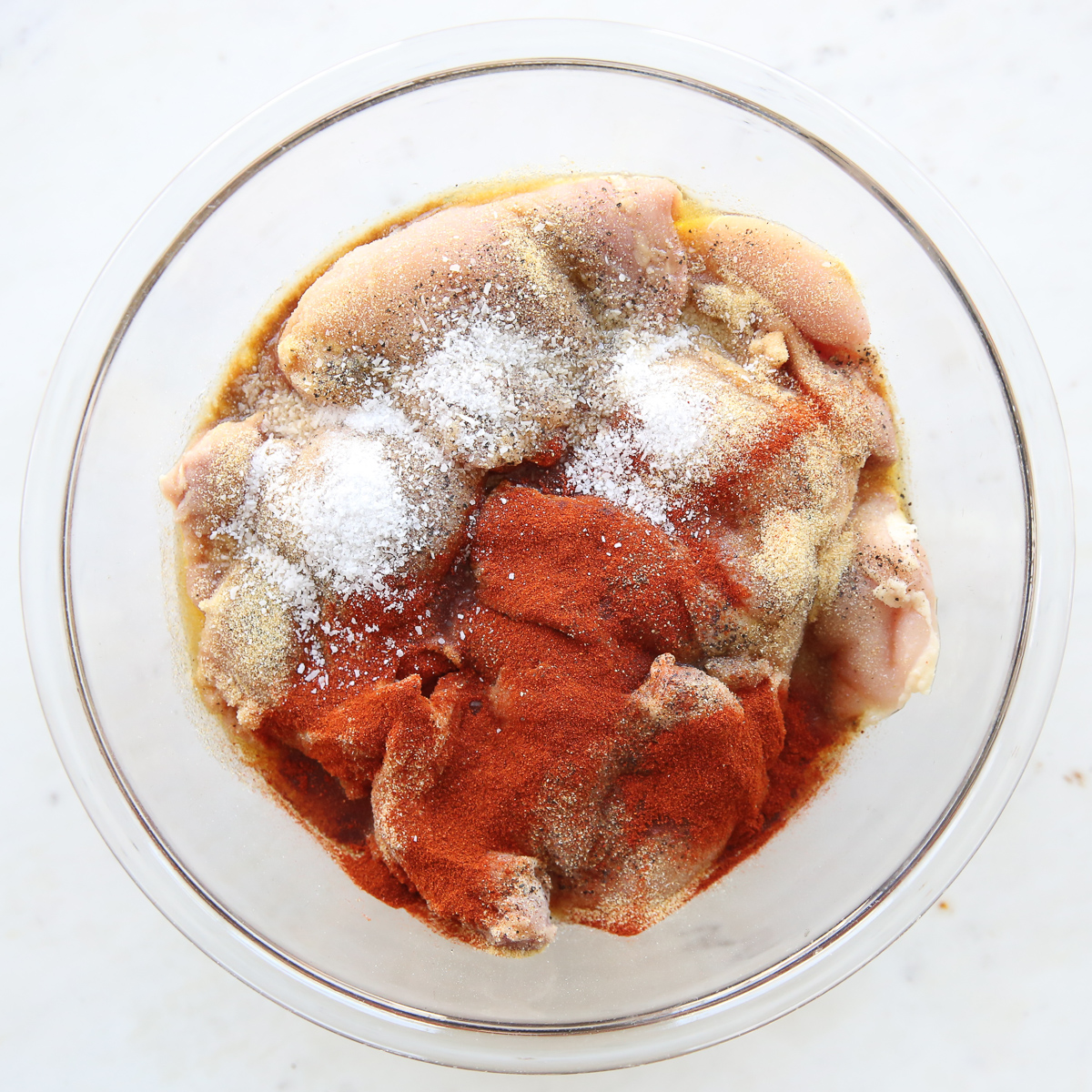 chicken thighs marinating with seasonings