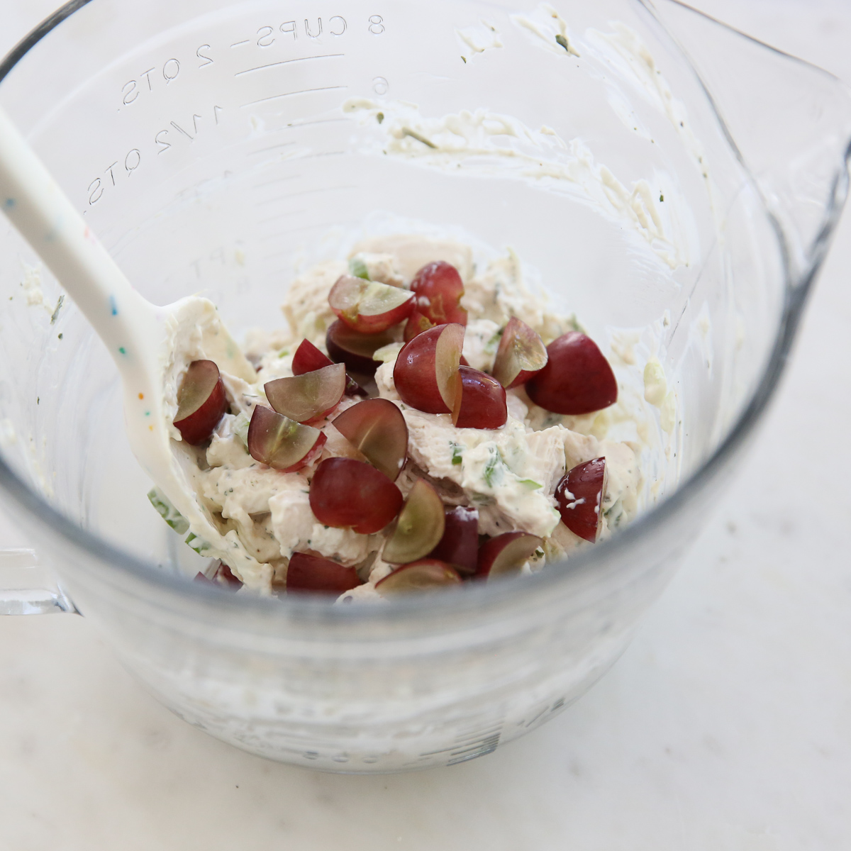 adding grapes to chicken salad