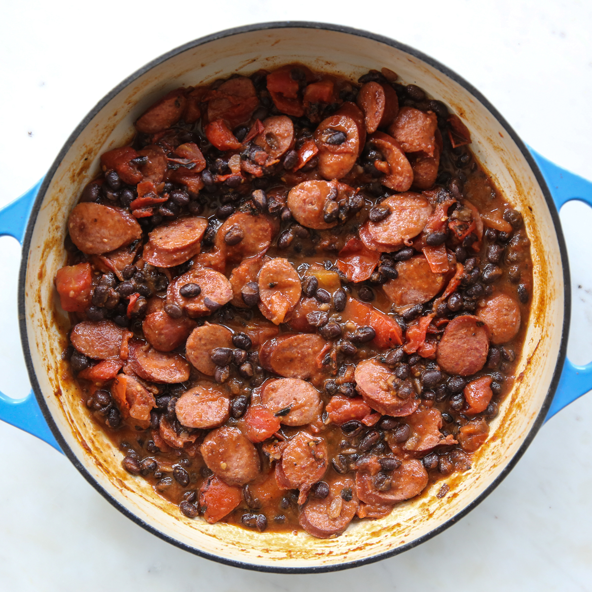black beans, tomatoes, and sausage cooked together in a skillet