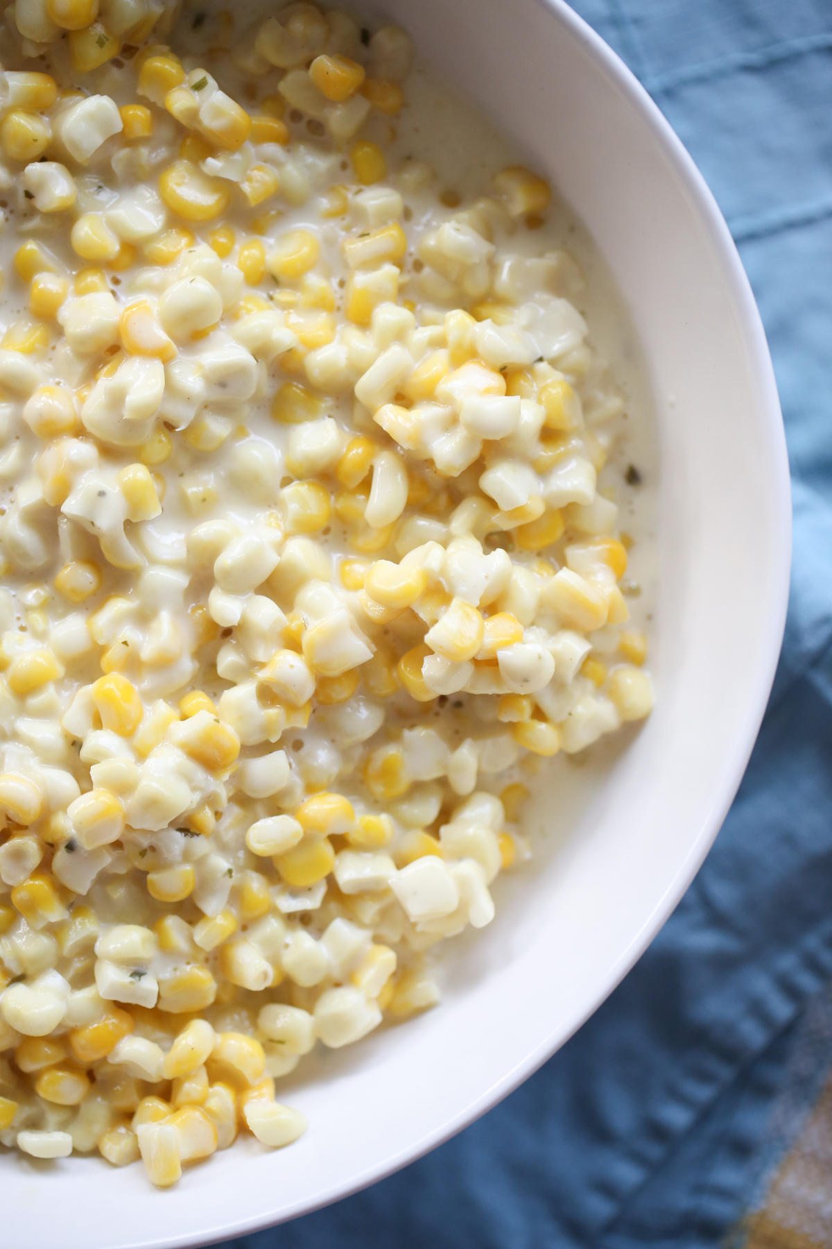 close up shot of creamed corn in a white bowl