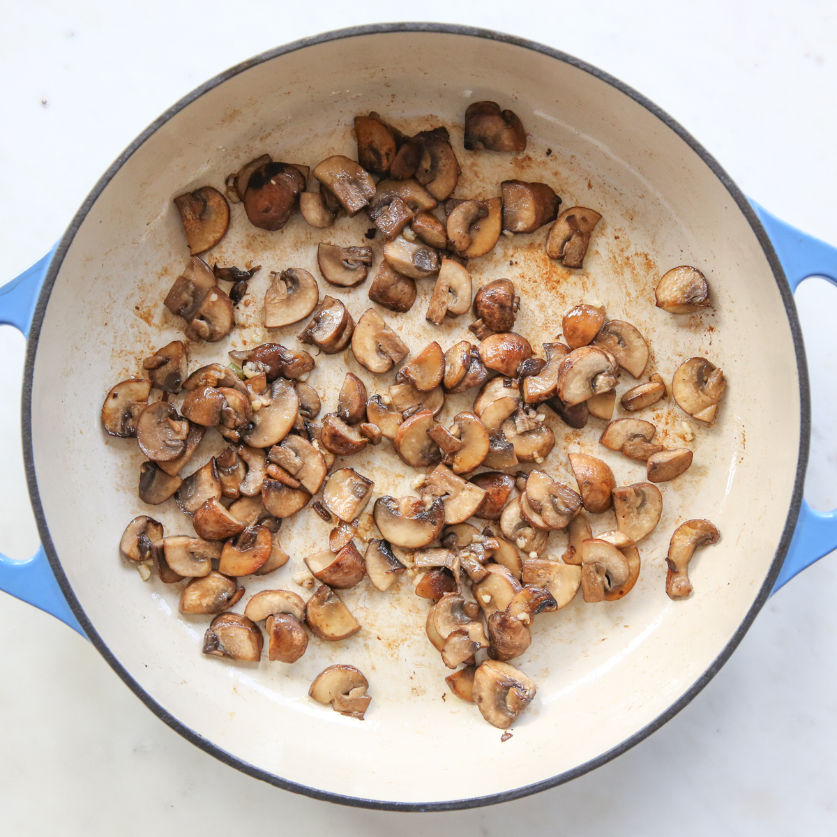 sauteeing mushrooms in a skillet
