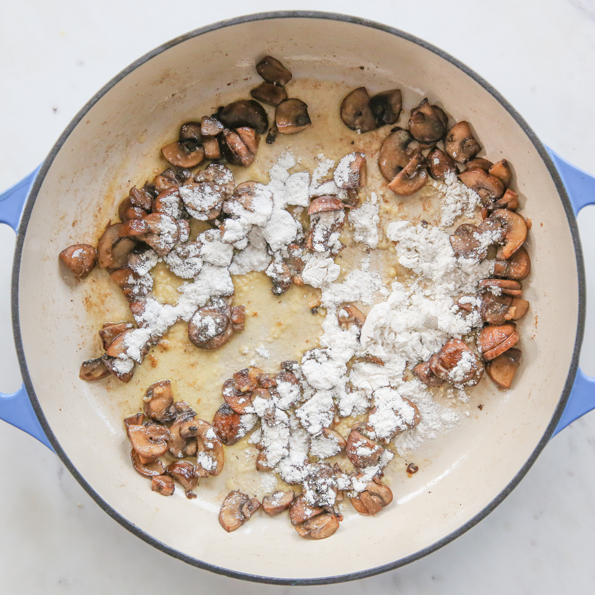 adding flour to the sauce of the green bean casserole