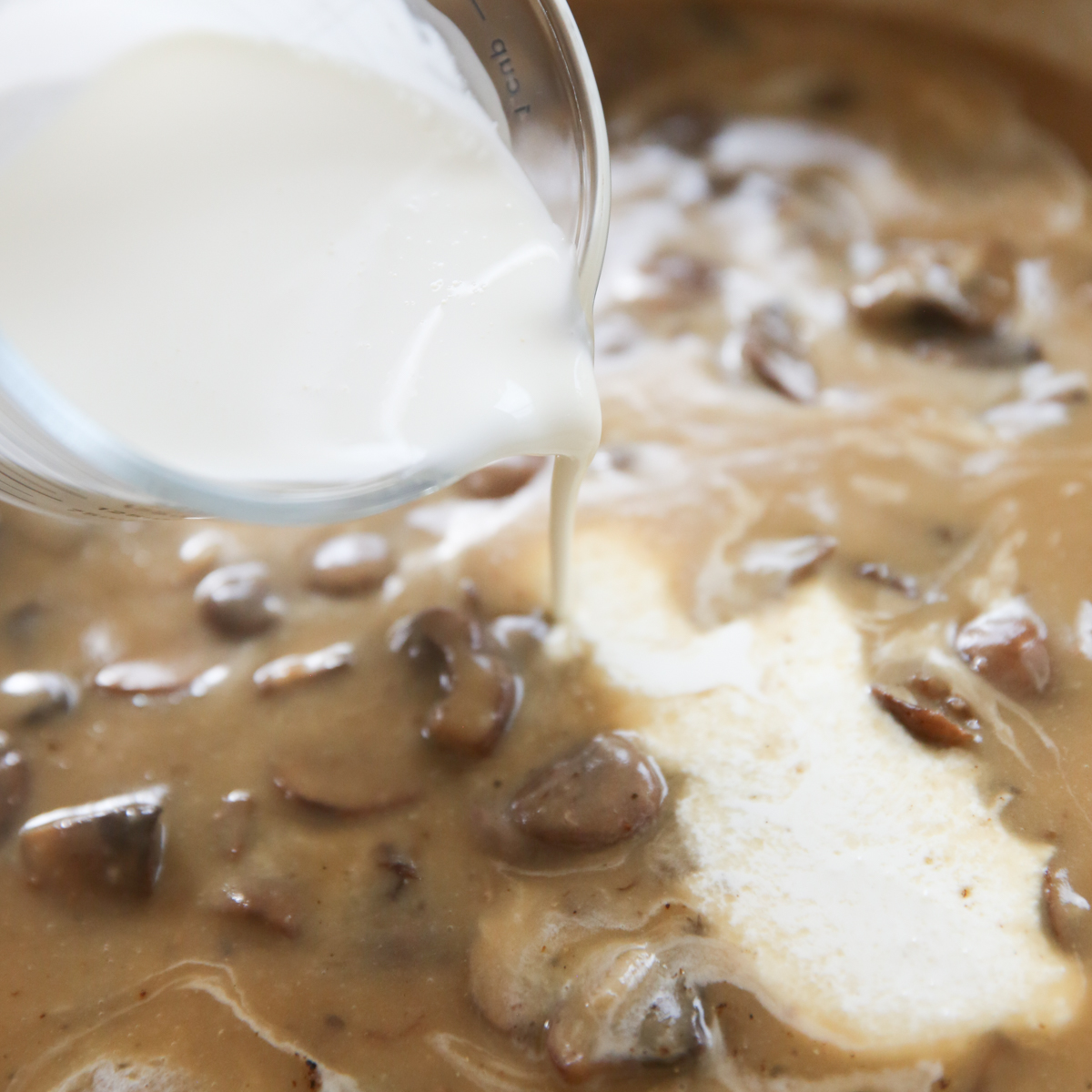 adding cream to fresh green bean casserole