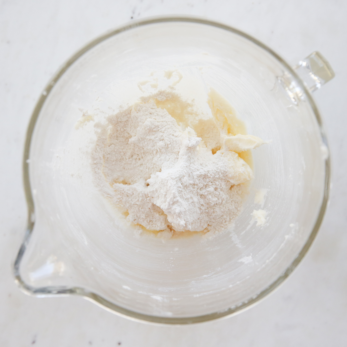 adding flour to cookie dough