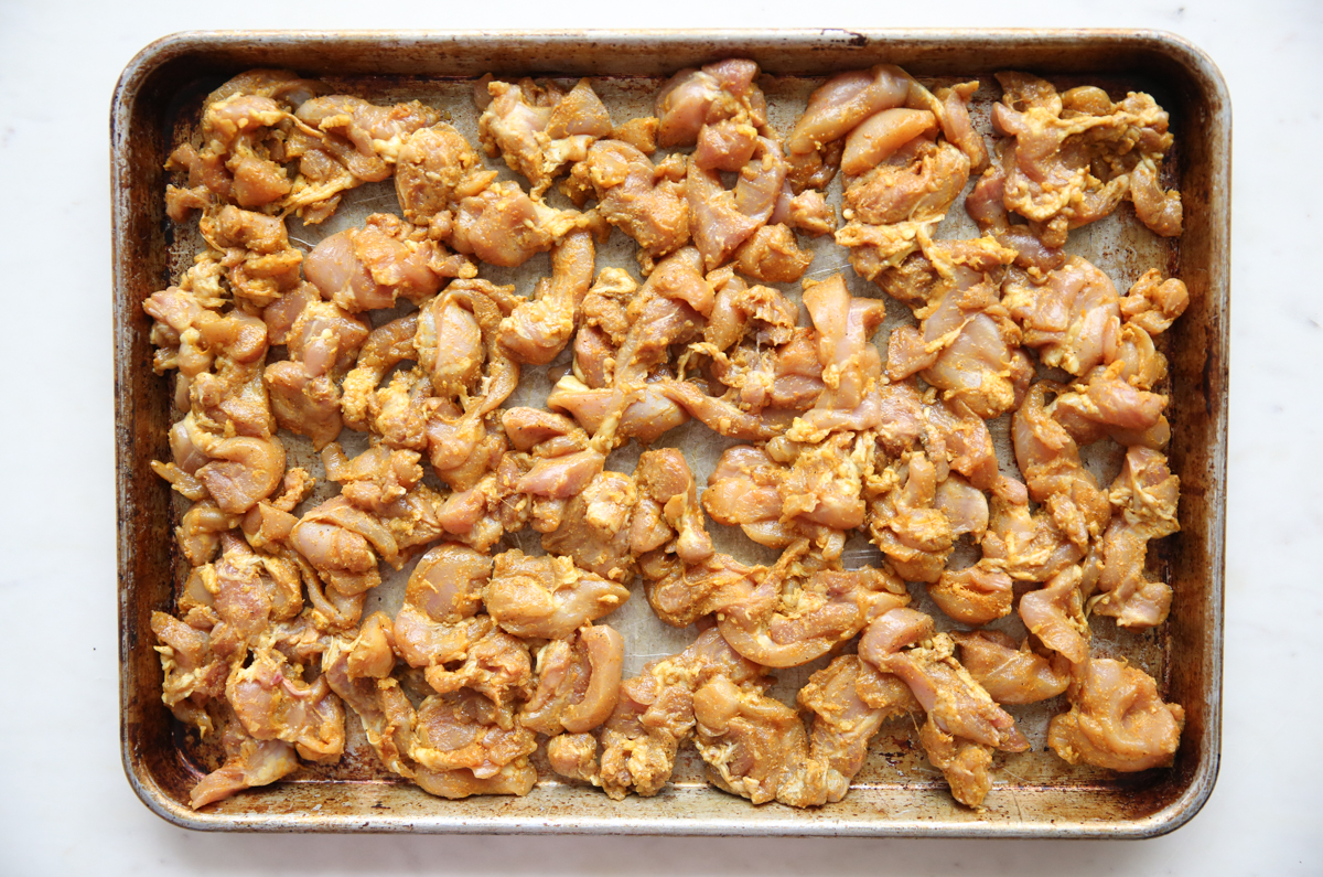 raw chicken on a sheet pan pre-cook
