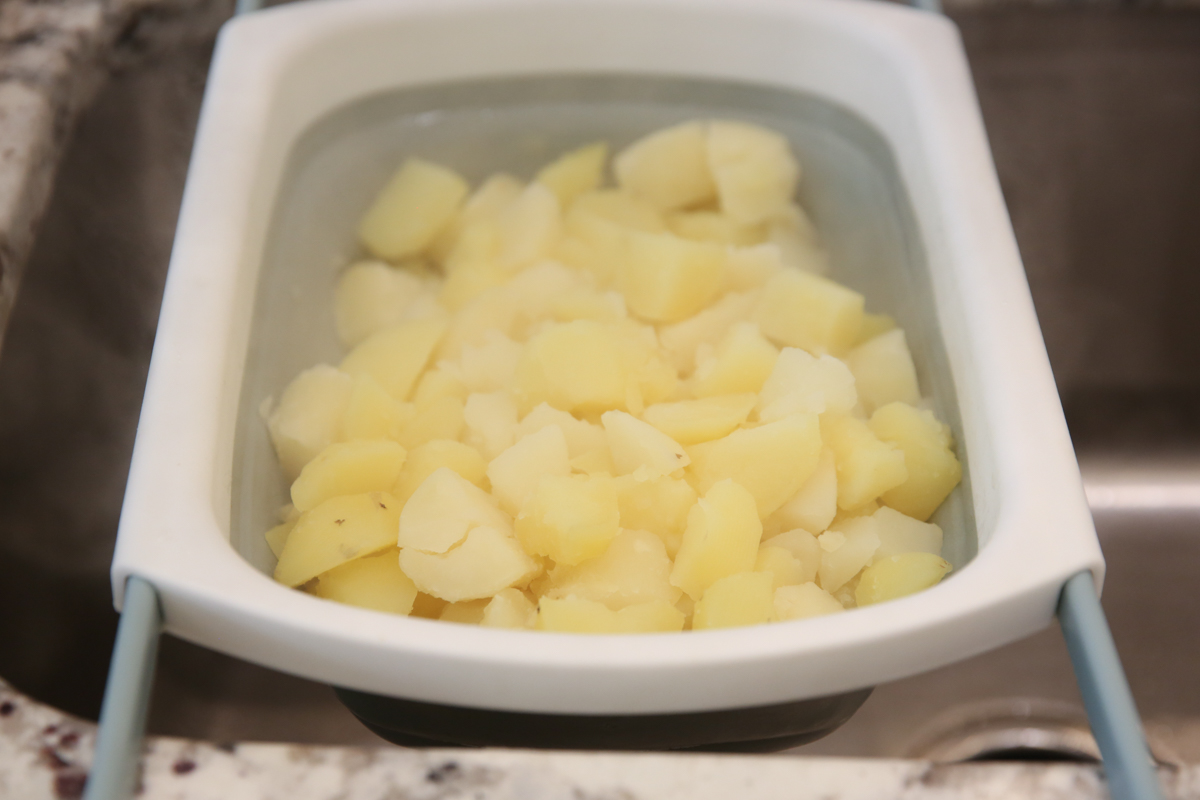 cooked potatoes in a strainer