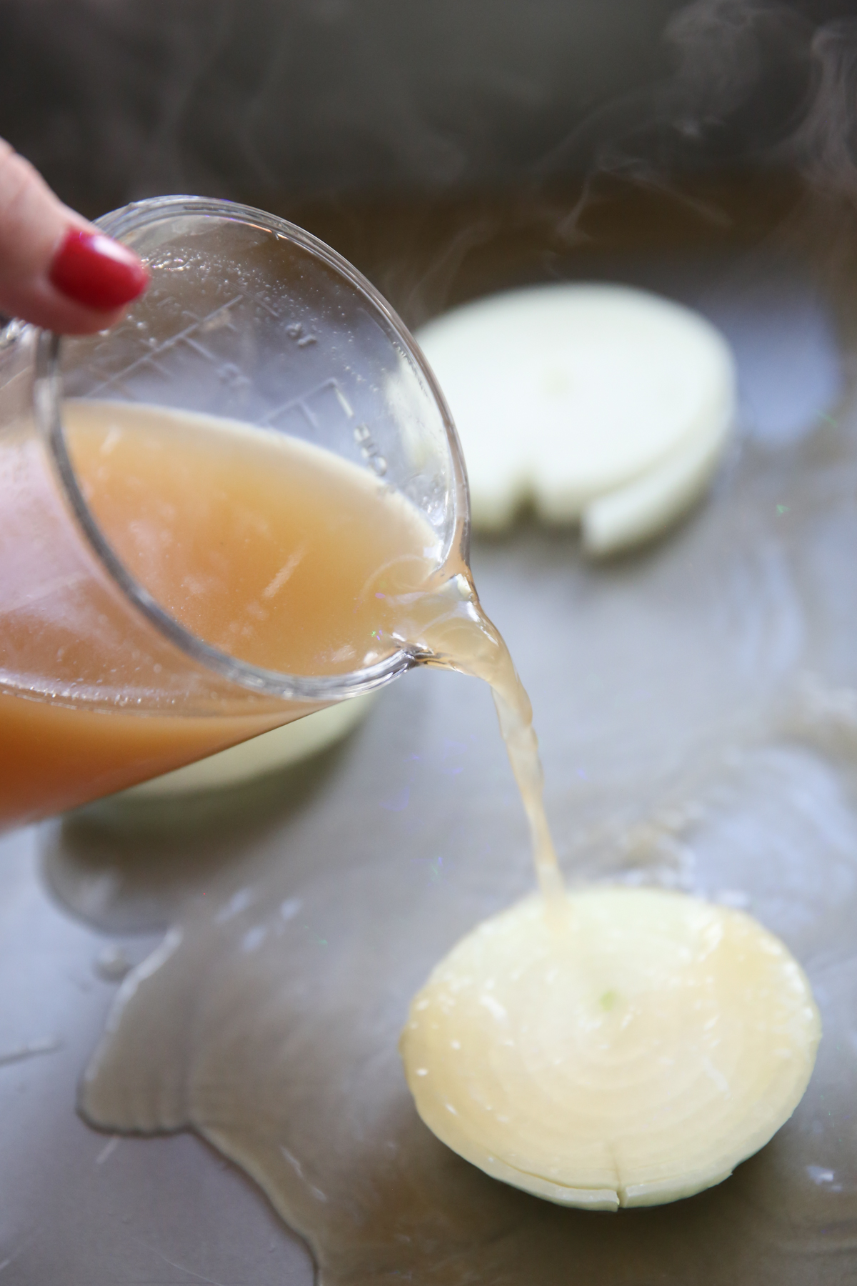 pouring broth into pan