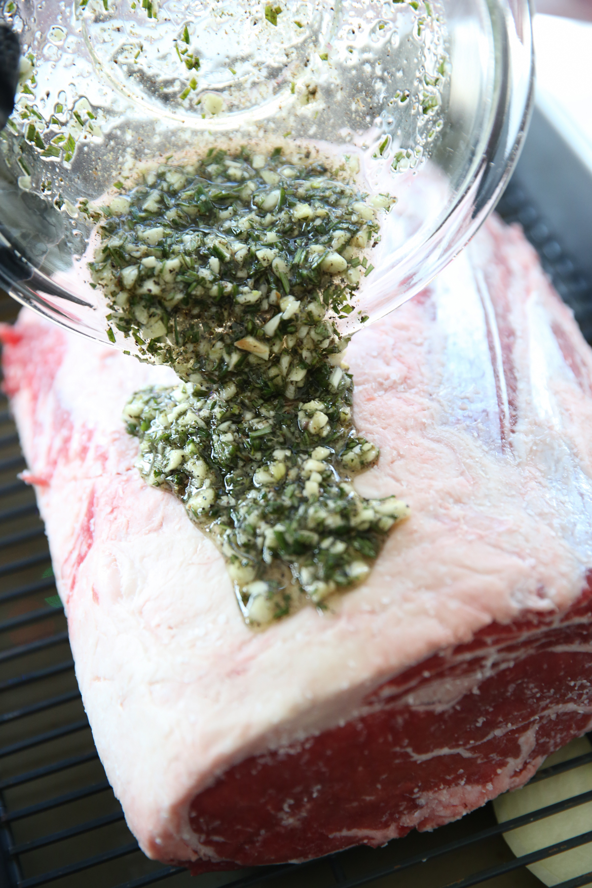 putting garlic rub on a roast