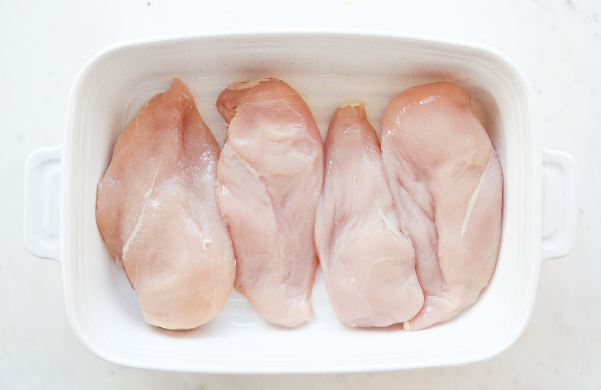 chicken breasts in a white baking dish