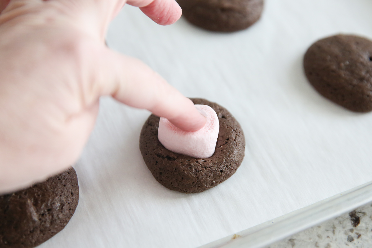pressing marshmallow into cookie dough