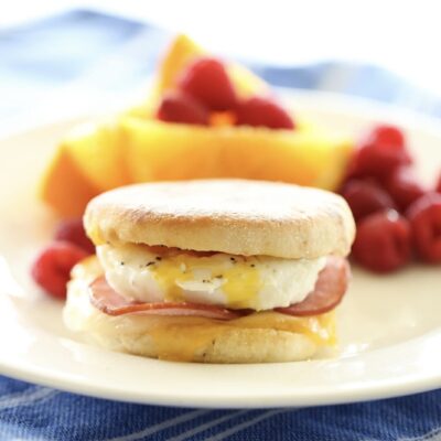 Egg Sandwich on a plate with fresh fruit