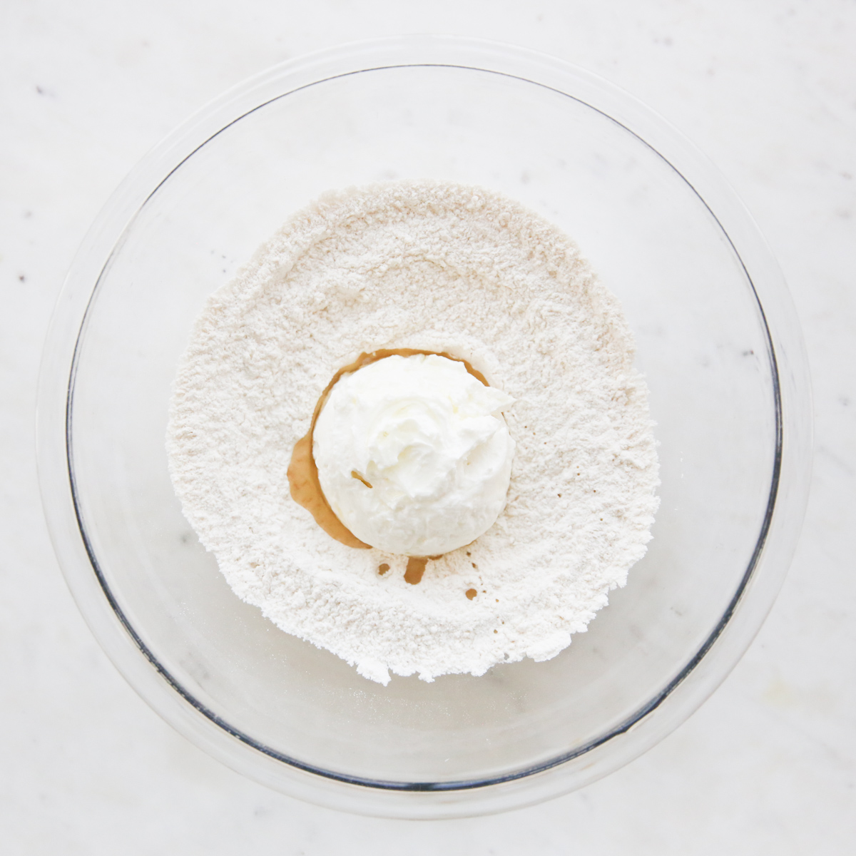 flour, oil, and yogurt in a bowl
