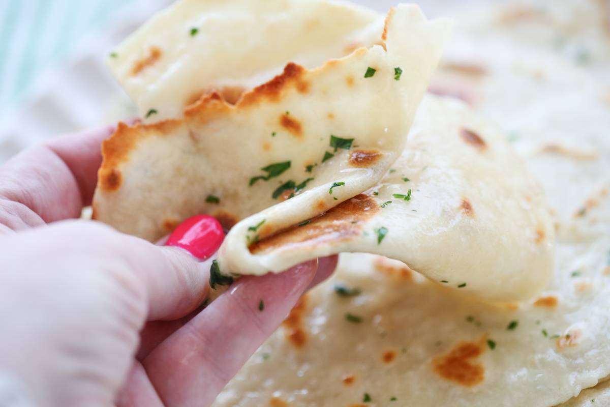 close up holding a folded flatbread