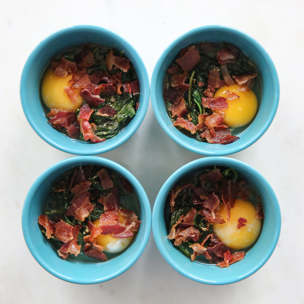baked eggs with bacon in ramekins
