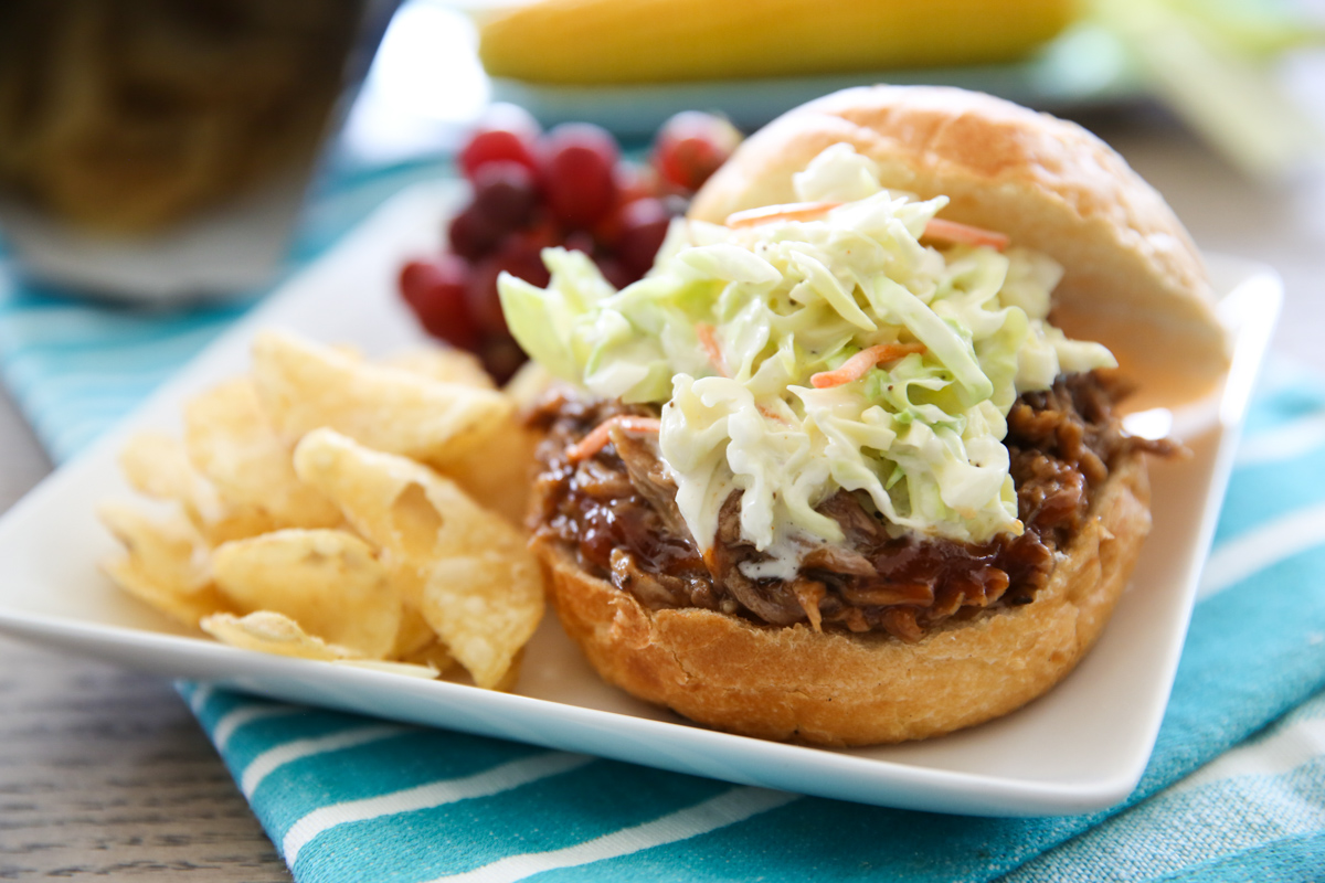 bbq pulled pork on a bun with coleslaw on top