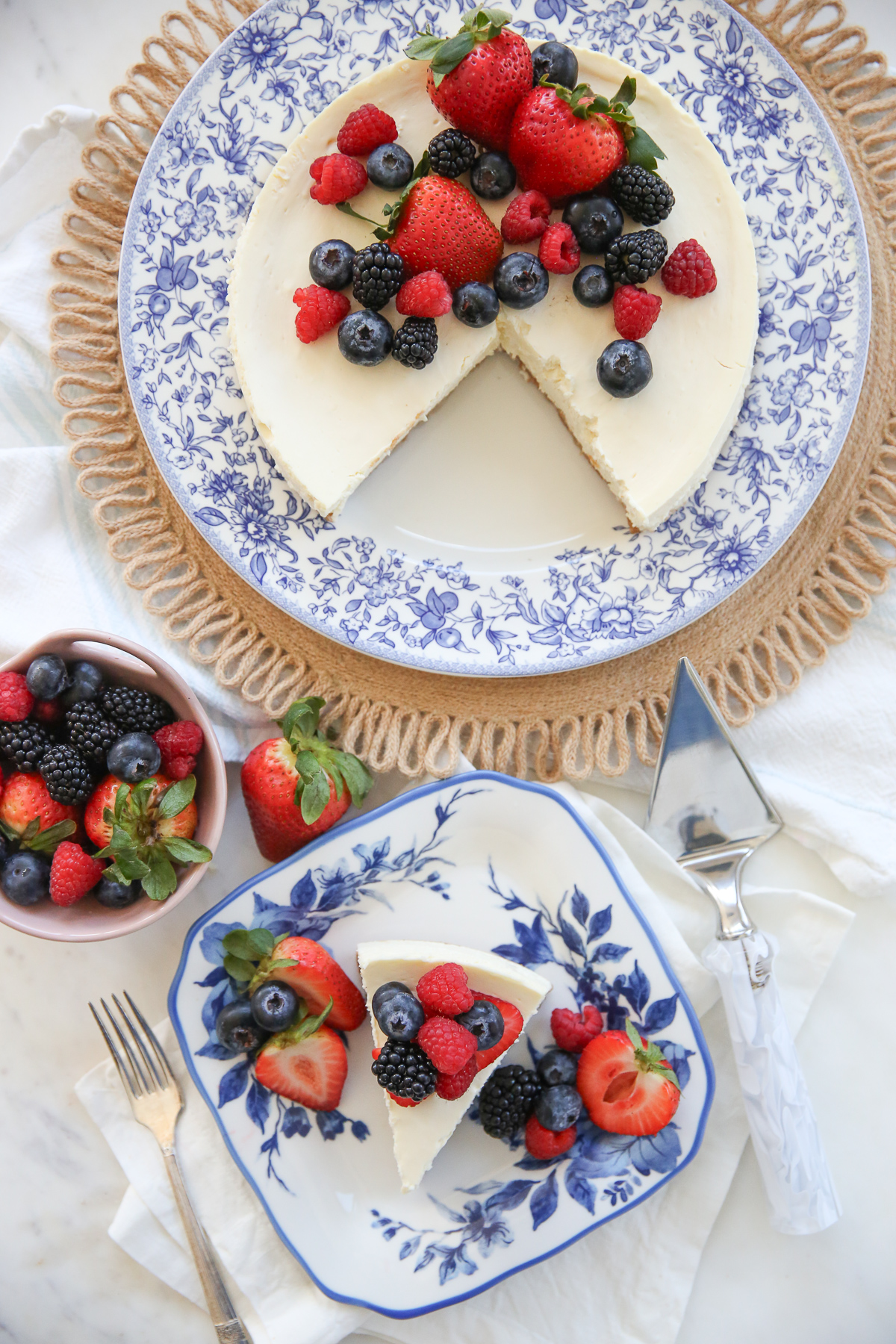 overhead shot of slice of cheesecake on a plate with fresh berries
