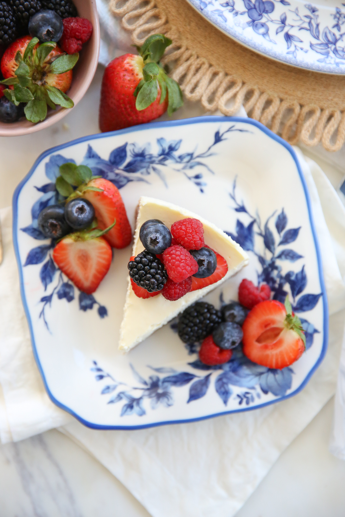 slice of cheesecake on a plate with fresh berries