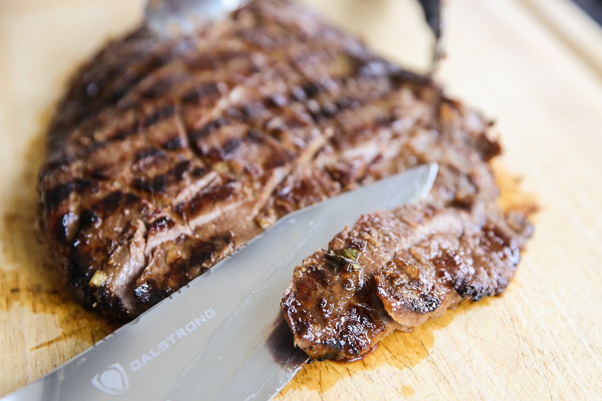 Sliced Ginger Soy Flank Steak on a cutting board