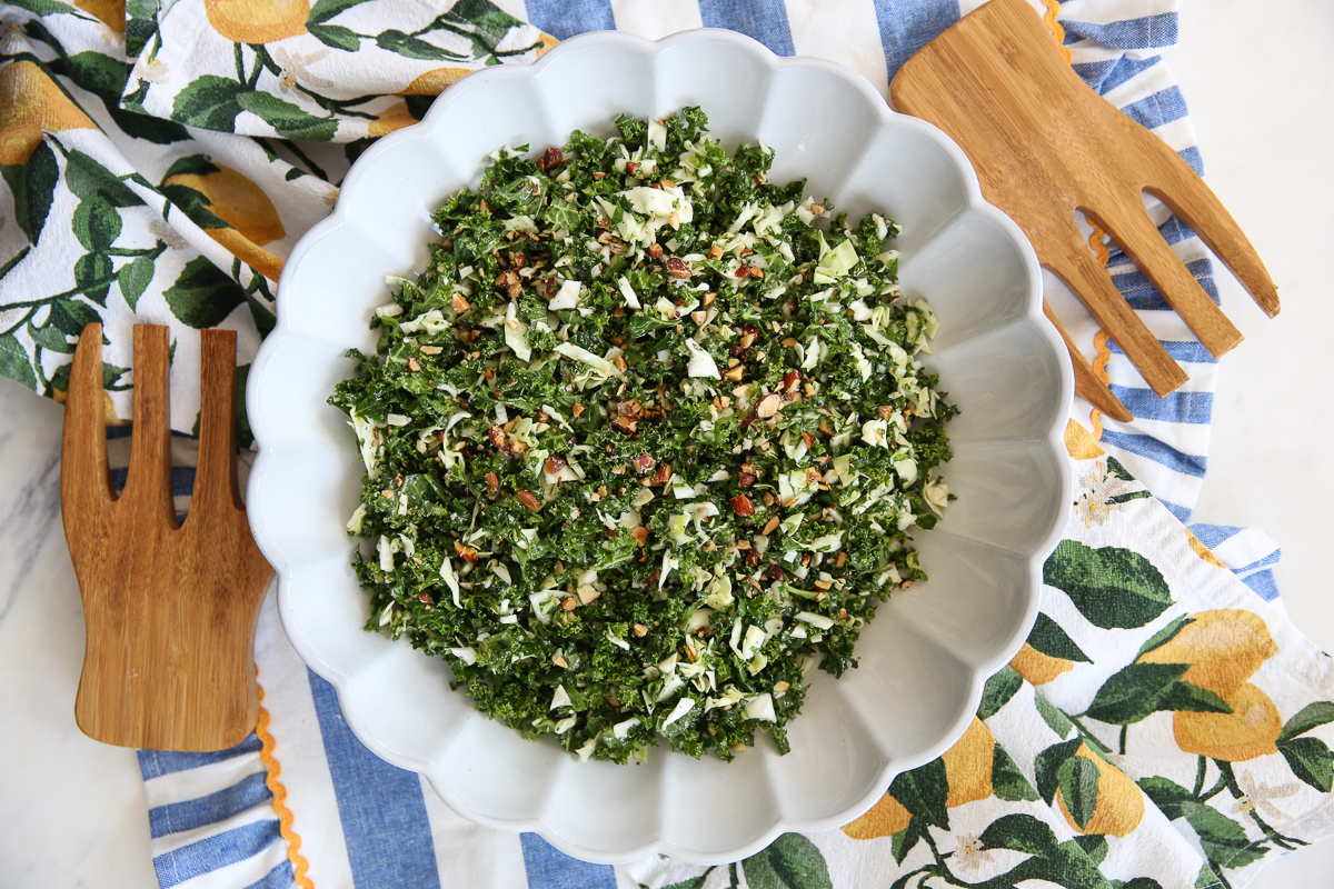 Kale crunch salad in a white bowl on a serving table