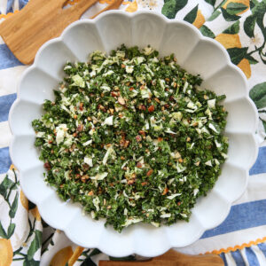 Kale crunch salad in a white bowl on a serving table