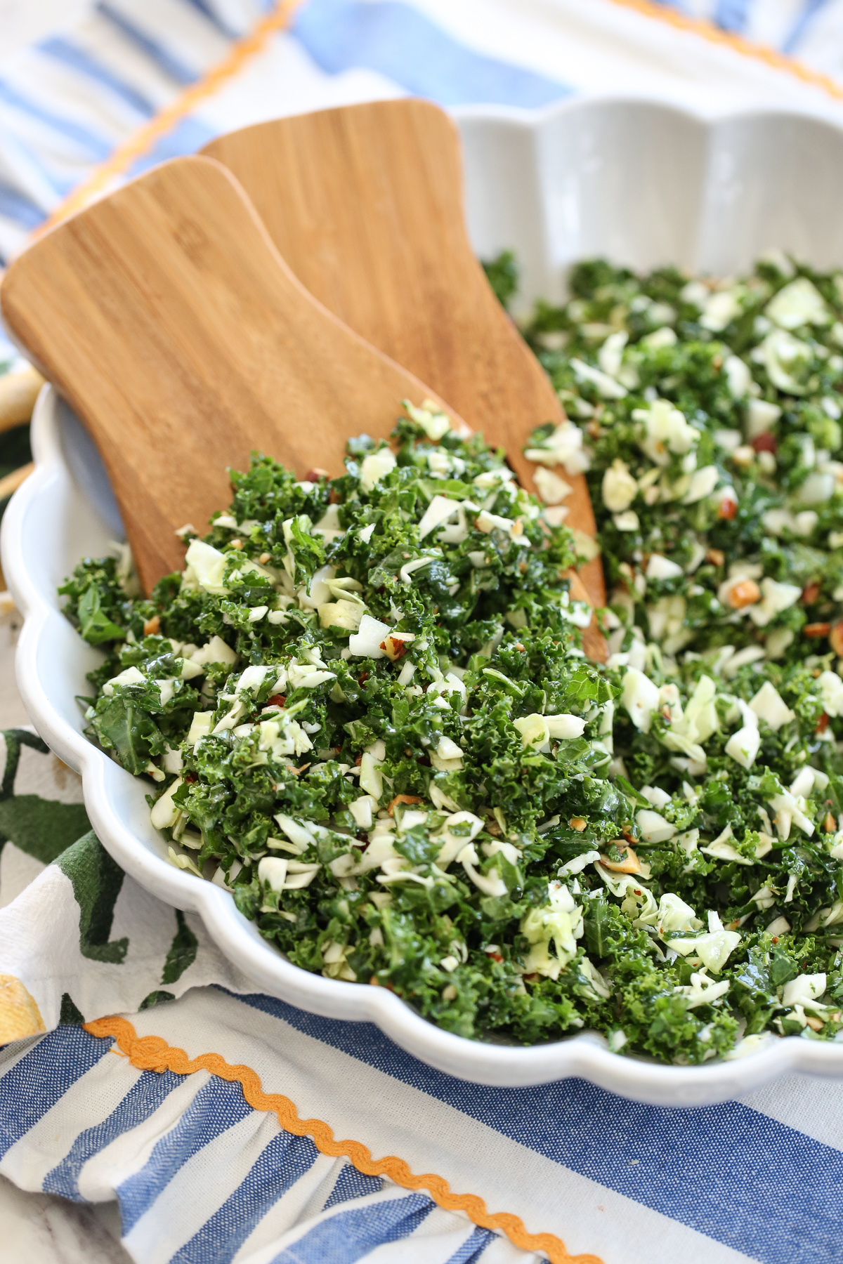 Kale crunch salad in a white bowl on a serving table
