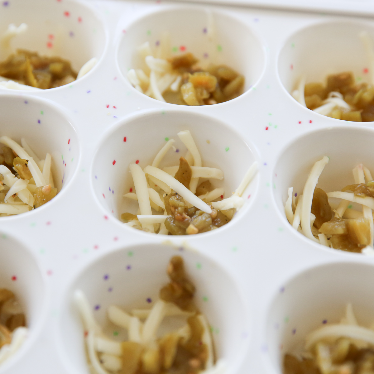 cheese and chilis in muffin cups
