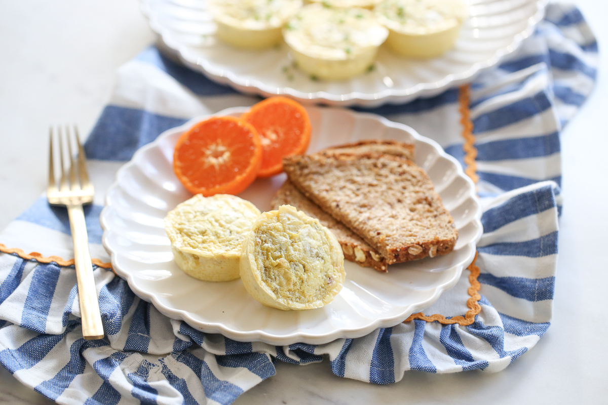 chili cheese egg bites on a plate with oranges and toast