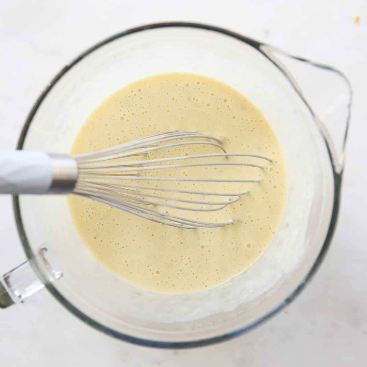 egg mixture in a bowl with a whisk
